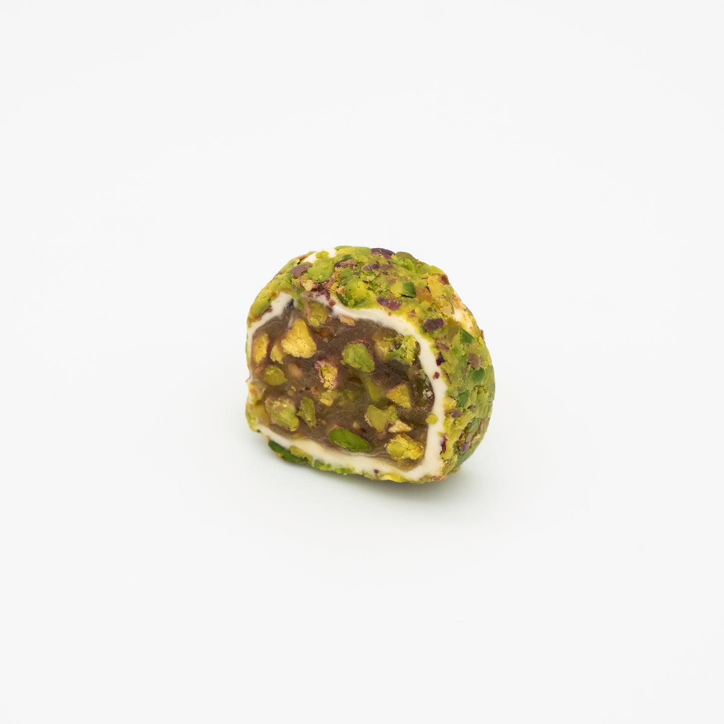 Pistachio crusted balls with honey paste, filling and pistachio halves 