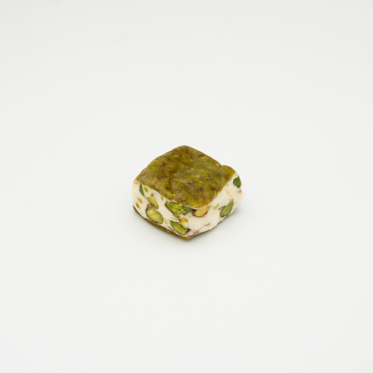 Pistachio powder crust filled with Helva and pistachio halves 